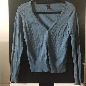 Woman’s blue cardigan sweater